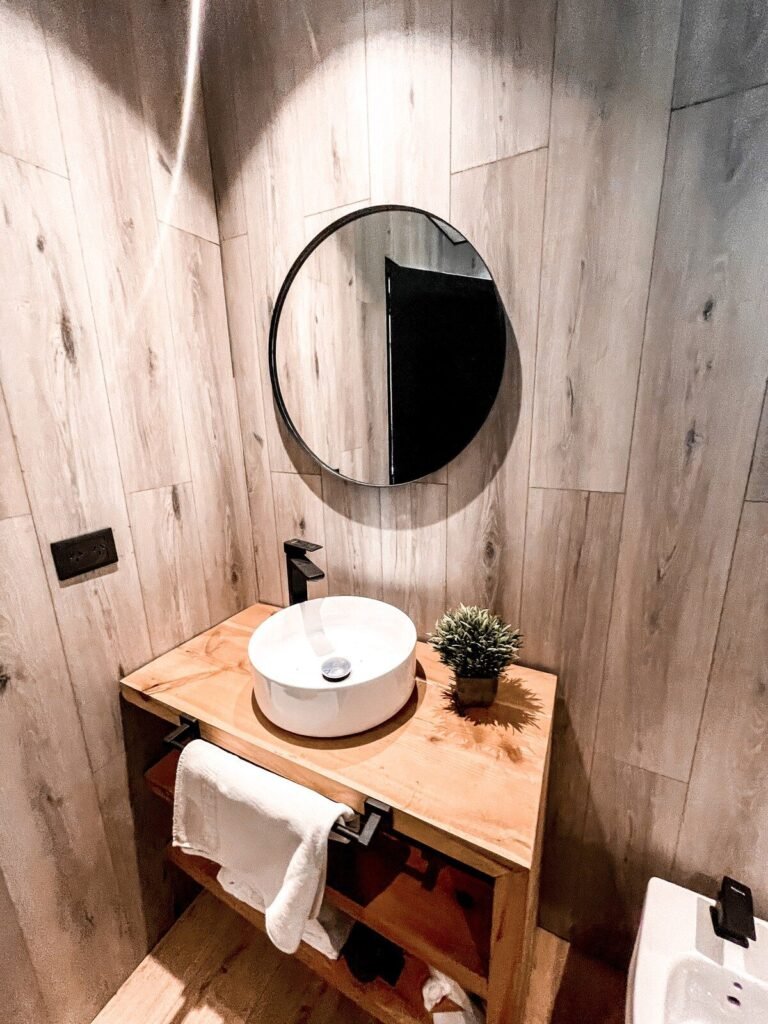 Bathroom with a vessel sink and a round mirror