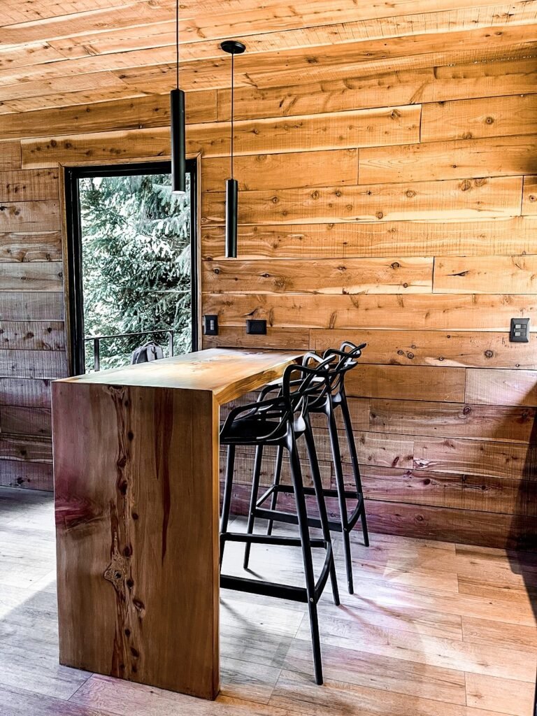 Wooden breakfast bar with stools by the window